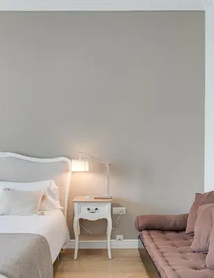 a bedroom with a bed and a couch and a lamp at Rambla Catalunya Sky in Barcelona