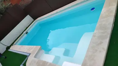 a large blue swimming pool in a house at Estrella Relax in Vallirana