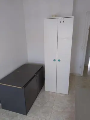 a black and white cabinet in a white room at Dormir sleep Comidad 100 in Barcelona