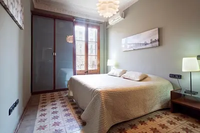 a bedroom with a bed and a large window at Catalunya Executive 3 bedrooms, 3 bathrooms AC wifi in Barcelona