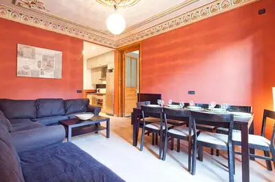 a living room with a couch and a table with chairs at Catalunya Executive 3 bedrooms, 3 bathrooms AC wifi in Barcelona