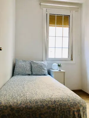 a bedroom with a bed and a window at Habitación privada junto al mar en la Barceloneta in Barcelona