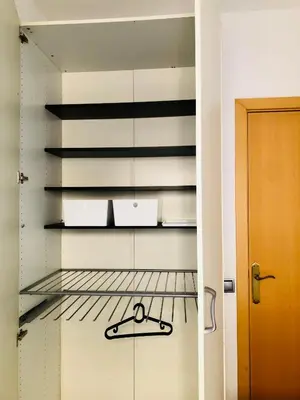 a kitchen with a shelf with boxes on it at Habitación privada junto al mar en la Barceloneta in Barcelona