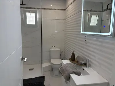 a bathroom with a toilet and a sink and a shower at FELIPE II Apartment in Barcelona