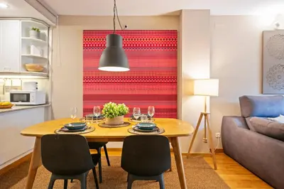 a kitchen and living room with a table and chairs at Click&Flat Charming Riera in Barcelona