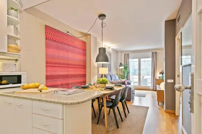 a kitchen with a table with chairs and a dining room at Click&Flat Charming Riera in Barcelona