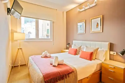 a bedroom with a bed with two towels on it at Click&Flat Charming Riera in Barcelona