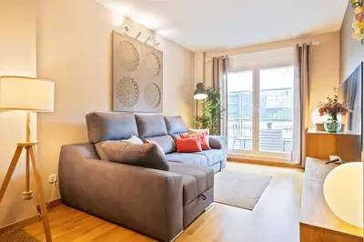 a living room with a couch and a window at Click&Flat Charming Riera in Barcelona