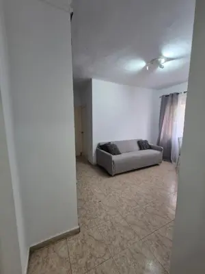 a living room with a couch in the corner of a room at Mary home in Barcelona