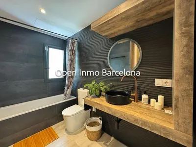 a bathroom with a sink and a toilet and a mirror at Alquiler temporal en Canyelles - OI01937 in Canyelles