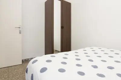 a bedroom with a bed and a mirror at Pubone AT Barberà del Valles in Barbera del Valles
