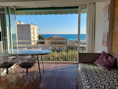 a living room with a table and a view of the ocean at Vistas al mar y garaje cerca de BCN in Sant Vicenç de Montalt