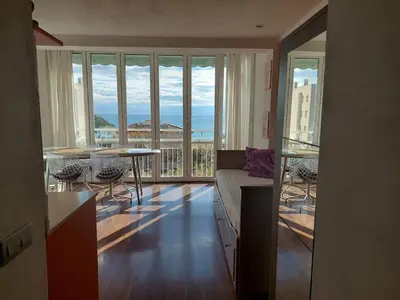 a living room with a couch and a view of the ocean at Vistas al mar y garaje cerca de BCN in Sant Vicenç de Montalt