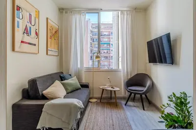 a living room with a couch and a window at Canela Homes BARCELONA ARC DE TRIOMF in Barcelona