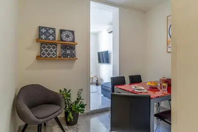 a dining room with a red table and chairs at Canela Homes BARCELONA ARC DE TRIOMF in Barcelona
