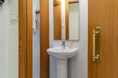 a bathroom with a sink and a mirror at Canela Homes BARCELONA ARC DE TRIOMF in Barcelona