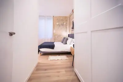 a small bedroom with a bed and a white room at 12Ara1093- New & Spacious 3BR Flat in Barcelona
