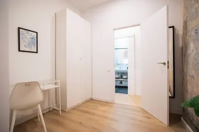 a white room with a desk and a chair at 12Ara1093- New & Spacious 3BR Flat in Barcelona