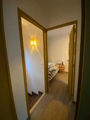 a hallway with a mirror and a bed in a room at House with pool & shared garden in Molins de Rei