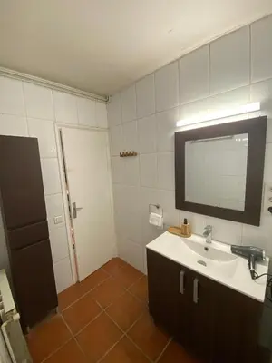a bathroom with a sink and a mirror at House with pool & shared garden in Molins de Rei