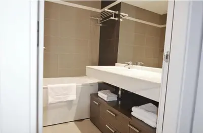 a bathroom with a sink and a tub and a mirror at Luz y Mar II in Barcelona