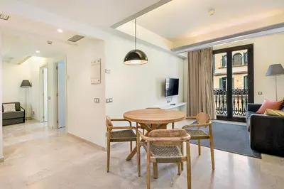 a living room with a table and chairs and a couch at Limonaia in Barcelona