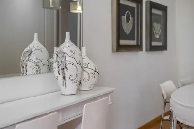 three white vases sitting on a table in a room at Stay U-nique Apartment Creu Coberta II in Barcelona