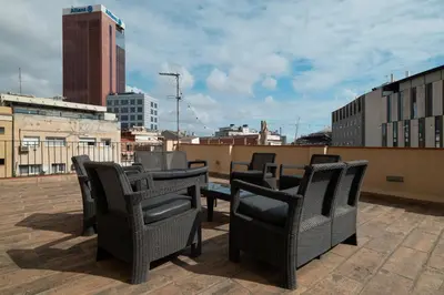 a group of chairs and tables on a roof at Stay U-nique Apartment Creu Coberta II in Barcelona