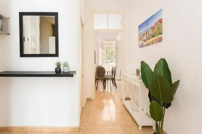 a living room with a mirror and a table at Apartament Clot 2 in Barcelona