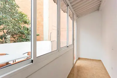 a room with large windows and a table at Apartament Clot 2 in Barcelona