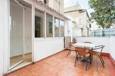 a balcony with a table and chairs on it at Apartament Clot 2 in Barcelona