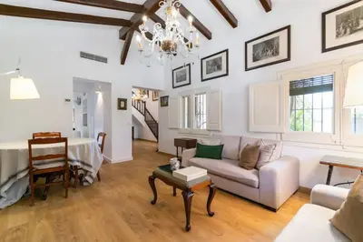 a living room with a couch and a table at Casa Alba Garden & Calm in Sitges