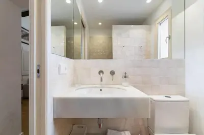 a white bathroom with a sink and a mirror at Casa Alba Garden & Calm in Sitges