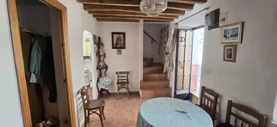 a room with a table and chairs and a staircase at Metrópolis in Barcelona