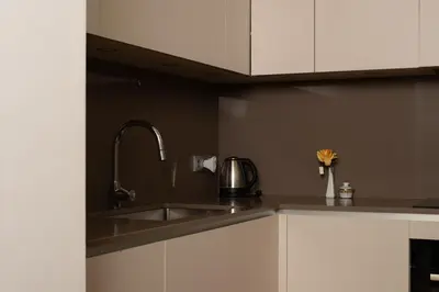 a kitchen with white cabinets and a sink at Cathedral Charm on Via Lantana in Barcelona