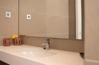 a bathroom with a sink and a mirror at Cathedral Charm on Via Lantana in Barcelona