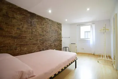 a bedroom with a brick wall and a bed at Apartment in the heart of Barcelona in Barcelona