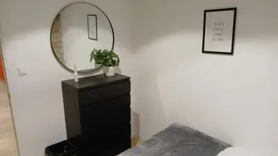 a bedroom with a black dresser and a mirror at Ink House in Barcelona