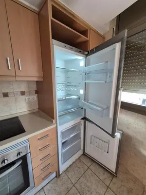 a kitchen with an empty refrigerator with its door open at Gran terrassa al cantó del mar in Canet de Mar