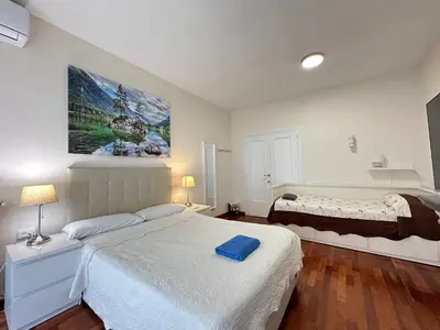 a bedroom with a large bed and a large painting on the wall at Apartamento en Viladomat in Barcelona