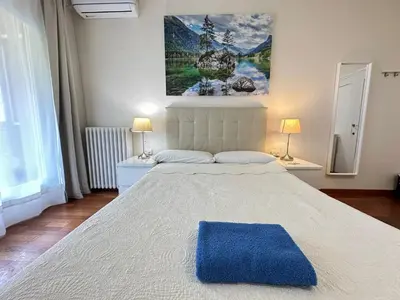 a bedroom with a large bed with a blue rug on it at Apartamento en Viladomat in Barcelona