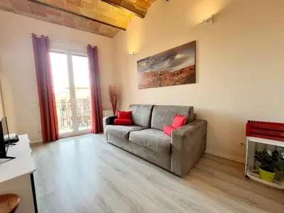 a living room with a couch and a fireplace at Bogatell Playa Apartment in Barcelona