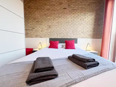 a bedroom with a bed with two towels on it at Bogatell Playa Apartment in Barcelona