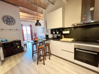 a kitchen with a table and chairs in a room at Bogatell Playa Apartment in Barcelona