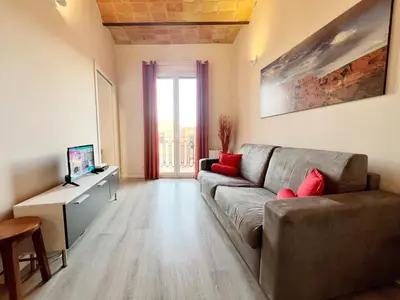 a living room with a couch and a television at Bogatell Playa Apartment in Barcelona