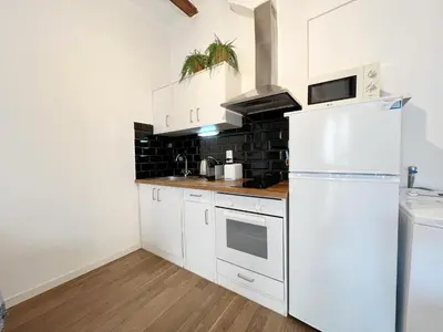 a kitchen with white appliances and a white refrigerator at Roser Apartment in Barcelona