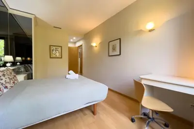 a bedroom with a bed and a desk and a chair at Gran Vía Sun in Barcelona