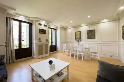 a living room with a table and a couch at Gran Vía Sun in Barcelona