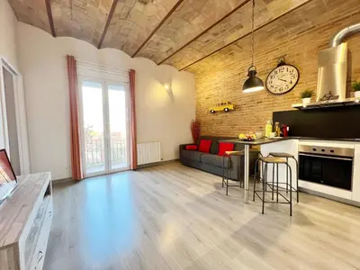a large living room with a couch and a table at Pamplona Playa Apartment in Barcelona