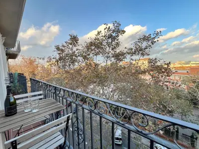 a balcony with a bench and a view of a city at Pamplona Playa Apartment in Barcelona